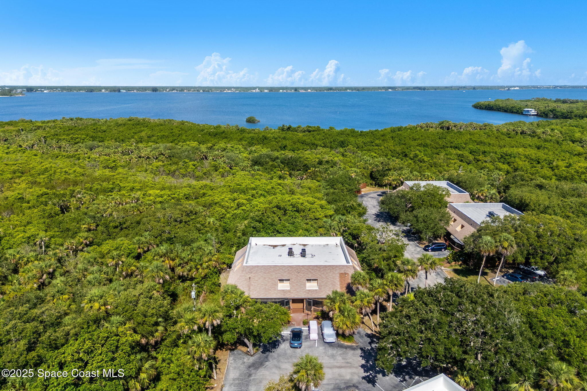 6205 Treetop Drive Melbourne Beach, FL 32951 - Photo 35 of 36 a view of an ocean and a houses