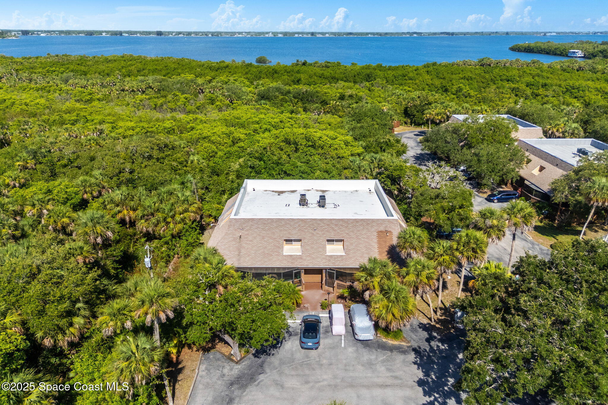 6205 Treetop Drive Melbourne Beach, FL 32951 - Photo 36 of 36 an aerial view of a house with a garden