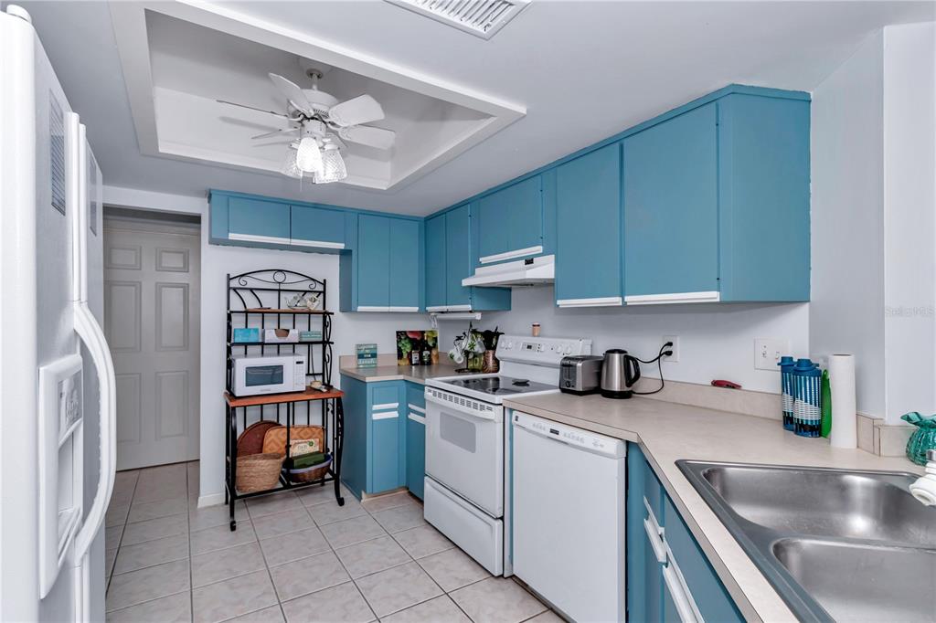 10901 Southwest 80th Court Ocala, FL 34481 - Photo 11 of 46 a kitchen with stainless steel appliances granite countertop a sink and cabinets