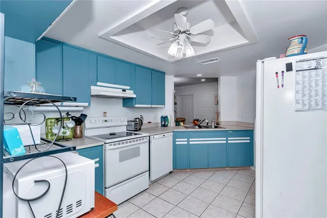 a kitchen with cabinets and chairs