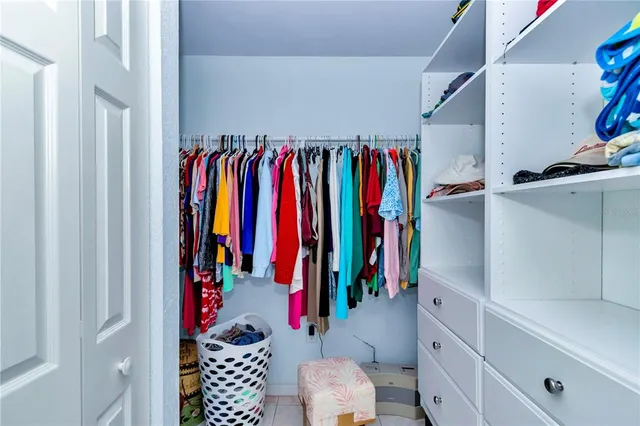 a bathroom with a granite countertop sink mirror vanity and toilet