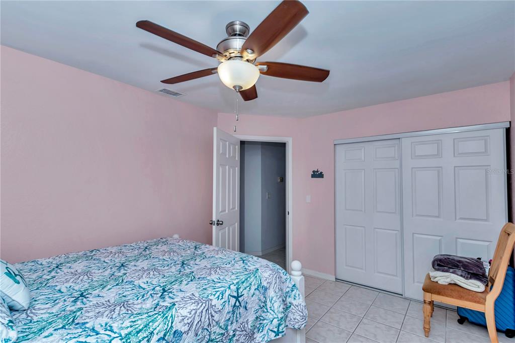 10901 Southwest 80th Court Ocala, FL 34481 - Photo 23 of 46 a bedroom with a bed and a chandelier