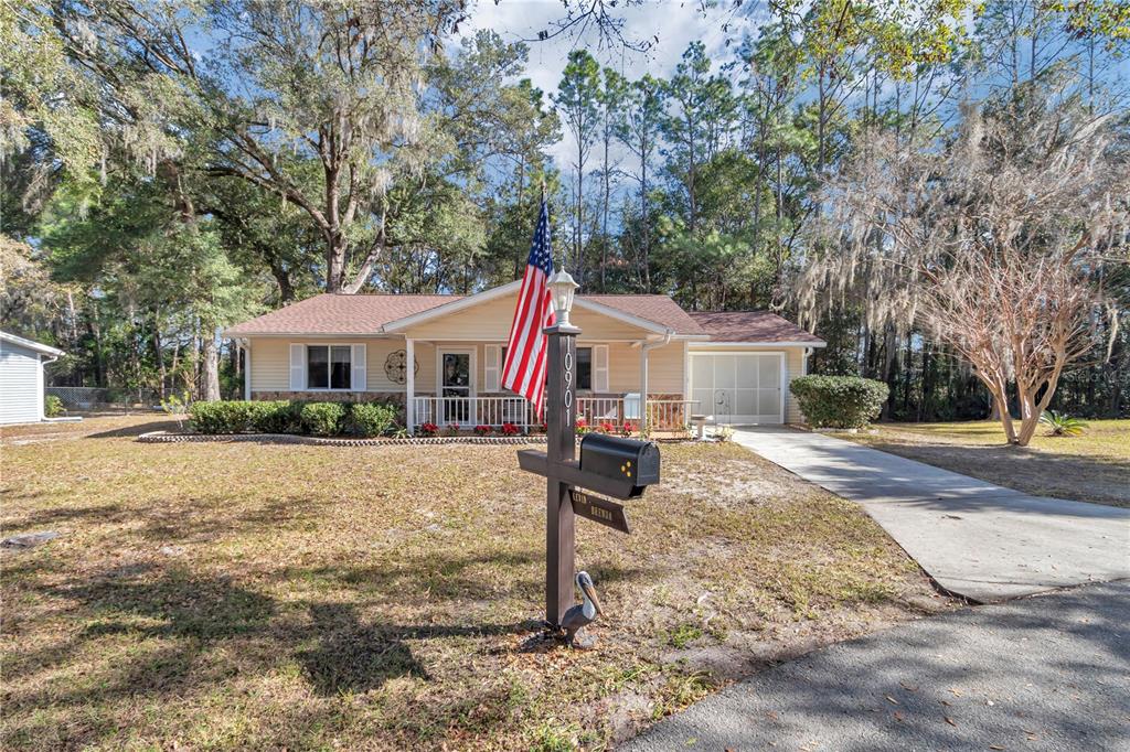 10901 Southwest 80th Court Ocala, FL 34481 - Photo 32 of 46 a front view of a house with a yard and garage