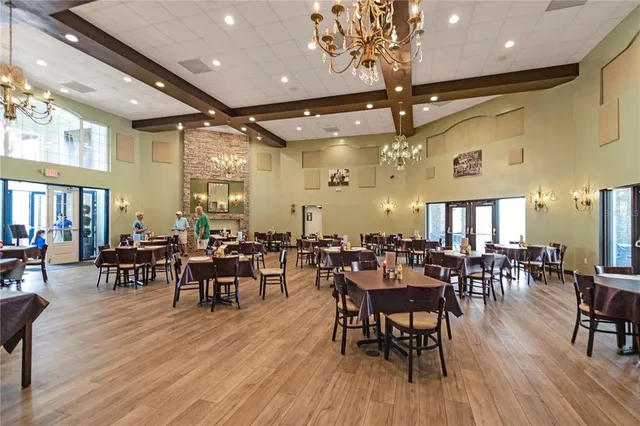 a dining room with furniture and a floor to ceiling window