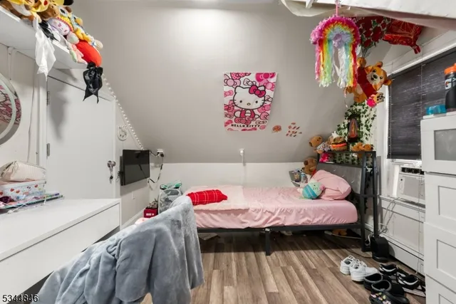 a bedroom with furniture and a flat screen tv