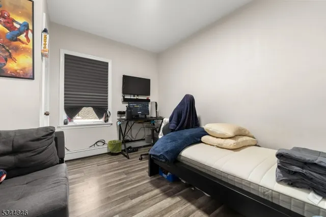 a backyard of a house with fire pit and couches under an umbrella