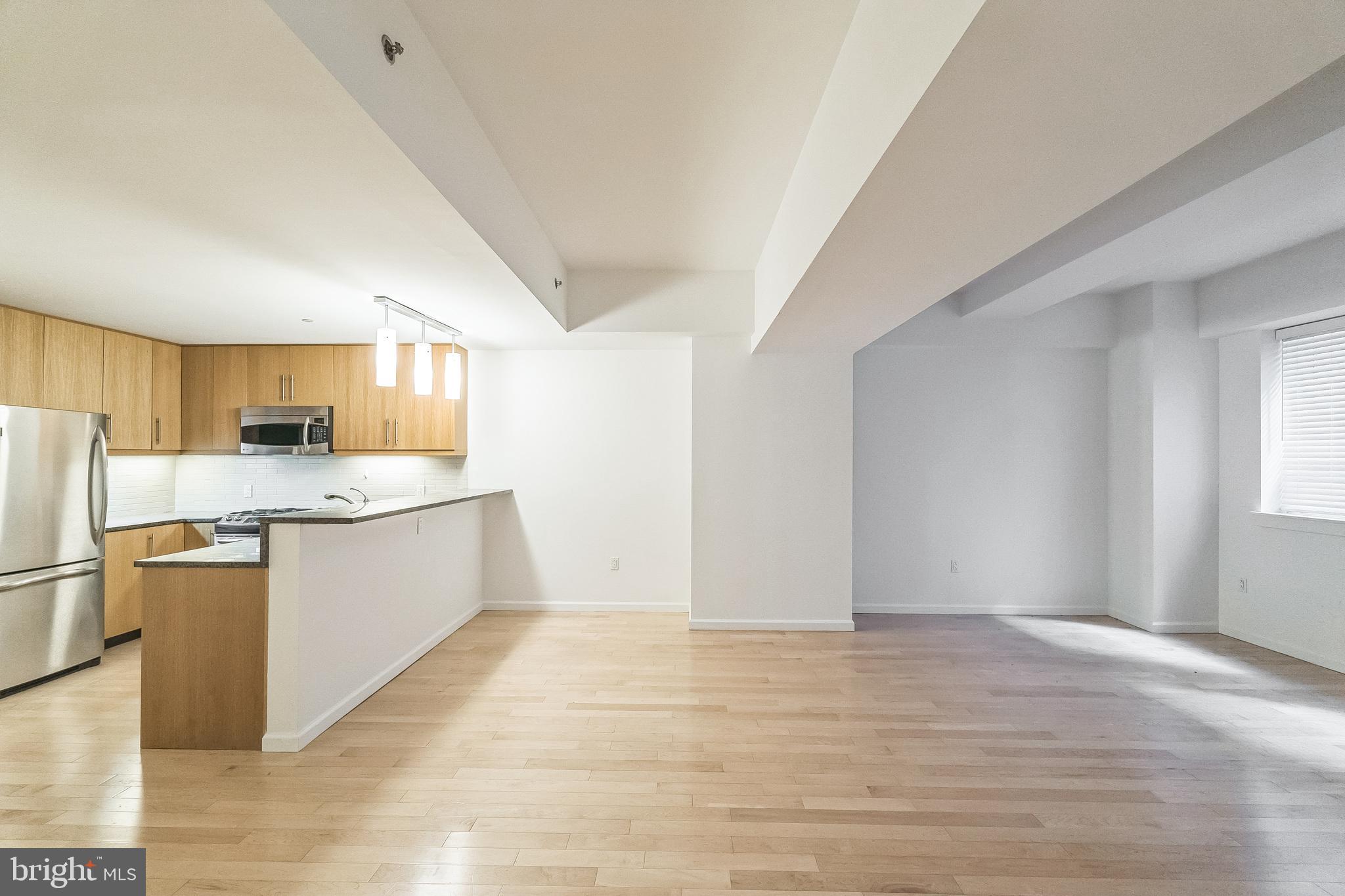 1425 Locust Street, Unit 3B Philadelphia, PA 19102 - Photo 2 of 13 a kitchen with stainless steel appliances granite countertop a refrigerator sink and white cabinets