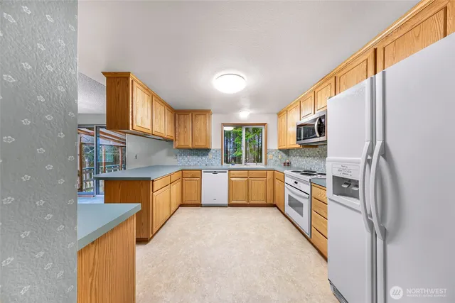 a kitchen with stainless steel appliances a sink and a refrigerator