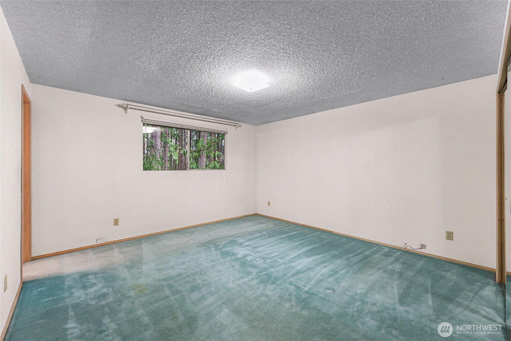 1834 Northeast Sumner Drive Oak Harbor, WA 98277 - Photo 18 of 37 an empty room with windows