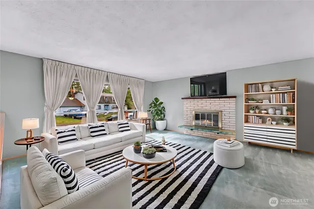 a living room with furniture a fireplace and a flat screen tv