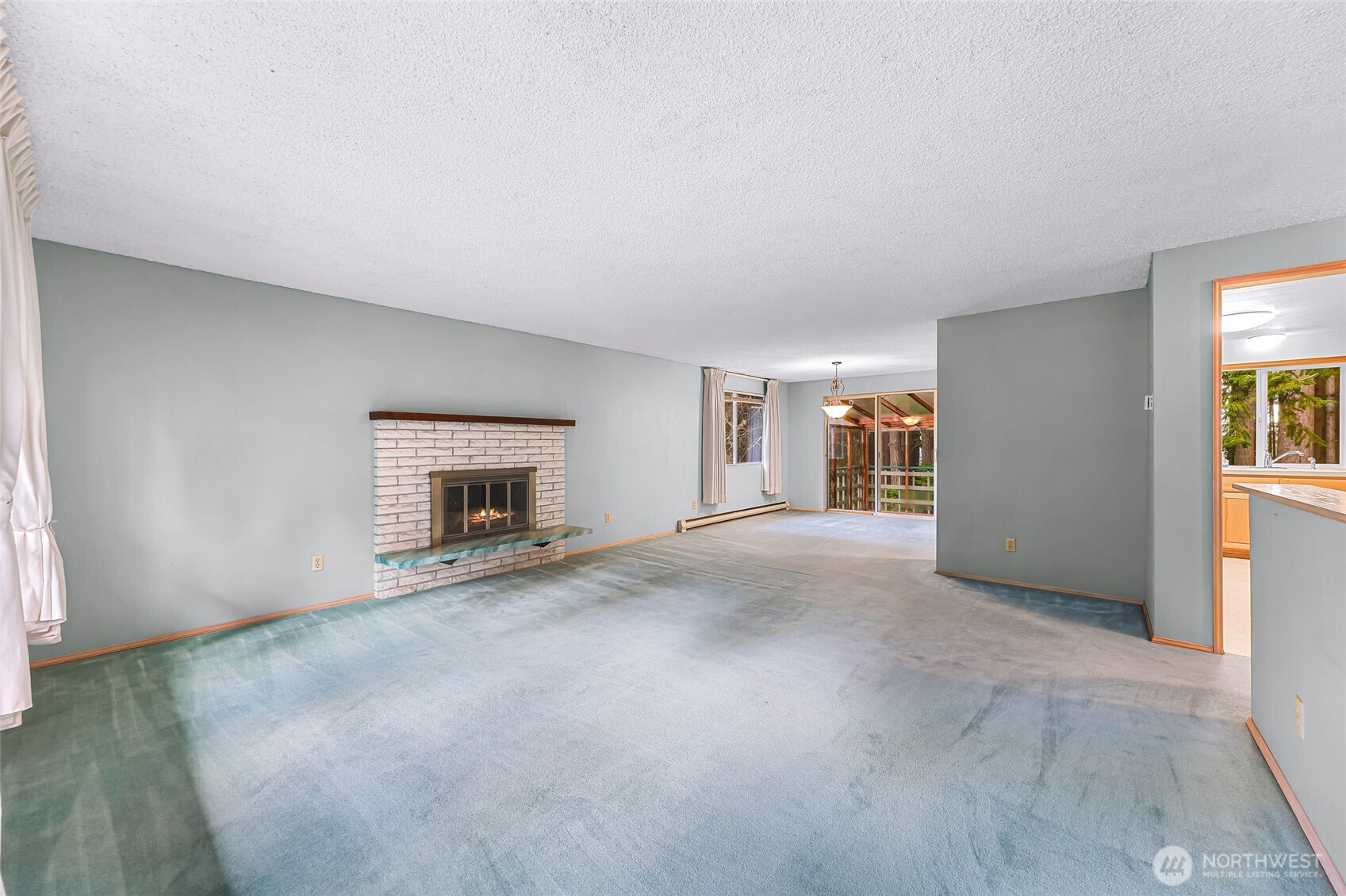 1834 Northeast Sumner Drive Oak Harbor, WA 98277 - Photo 4 of 37 an empty room with windows and fireplace