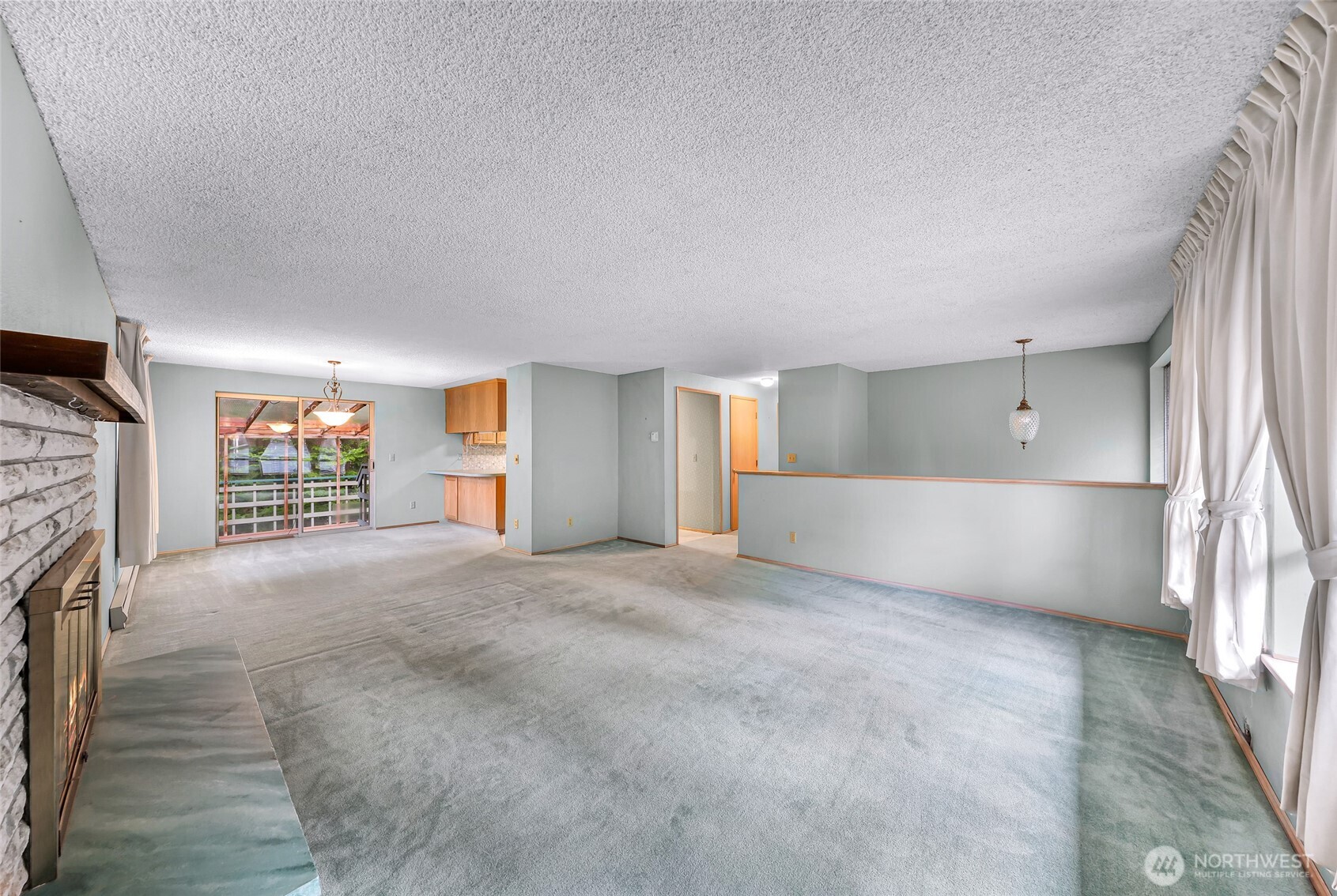 1834 Northeast Sumner Drive Oak Harbor, WA 98277 - Photo 5 of 37 a view of an empty room with a fireplace and a window