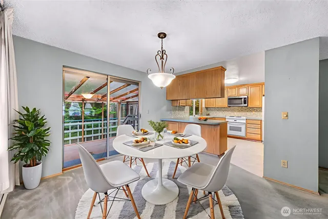 a dining room with furniture a window and wooden floor
