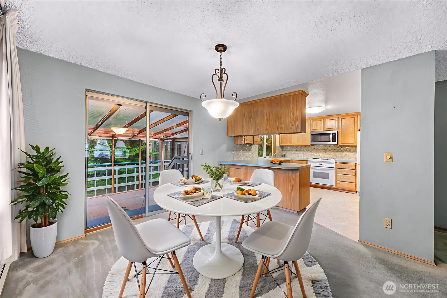1834 Northeast Sumner Drive Oak Harbor, WA 98277 - Photo 7 of 37 a dining room with furniture a window and wooden floor