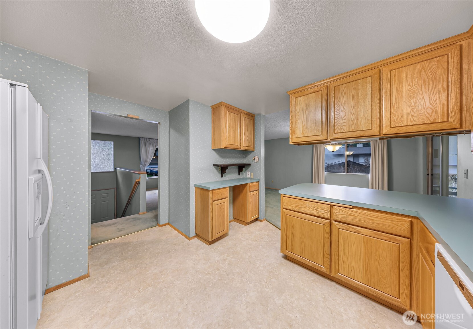1834 Northeast Sumner Drive Oak Harbor, WA 98277 - Photo 10 of 37 a kitchen with stainless steel appliances granite countertop a refrigerator a sink dishwasher a oven with large window