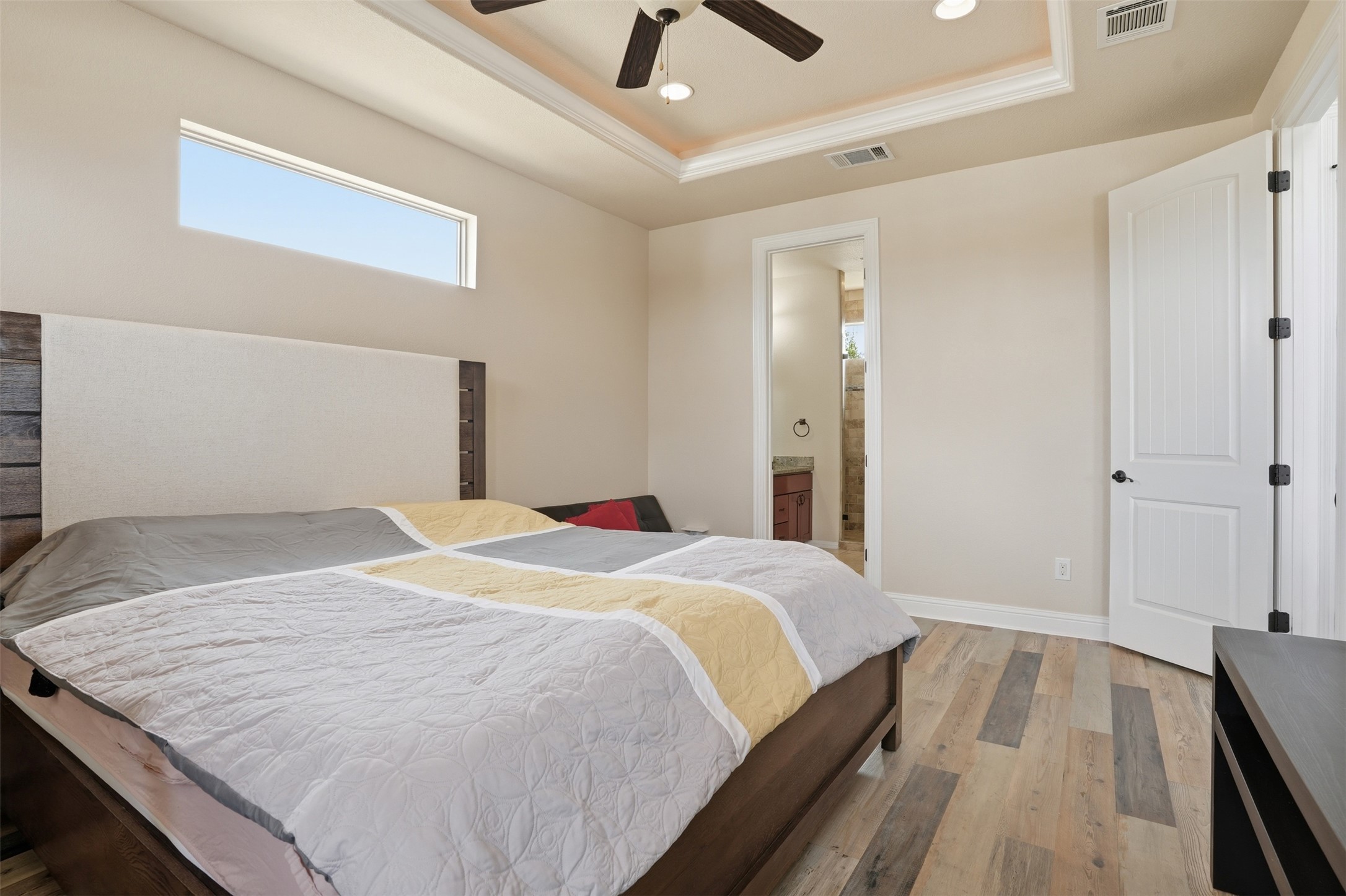 1185 Springdale Road Austin, TX 78721 - Photo 12 of 32 a bedroom with a bed and wooden floor