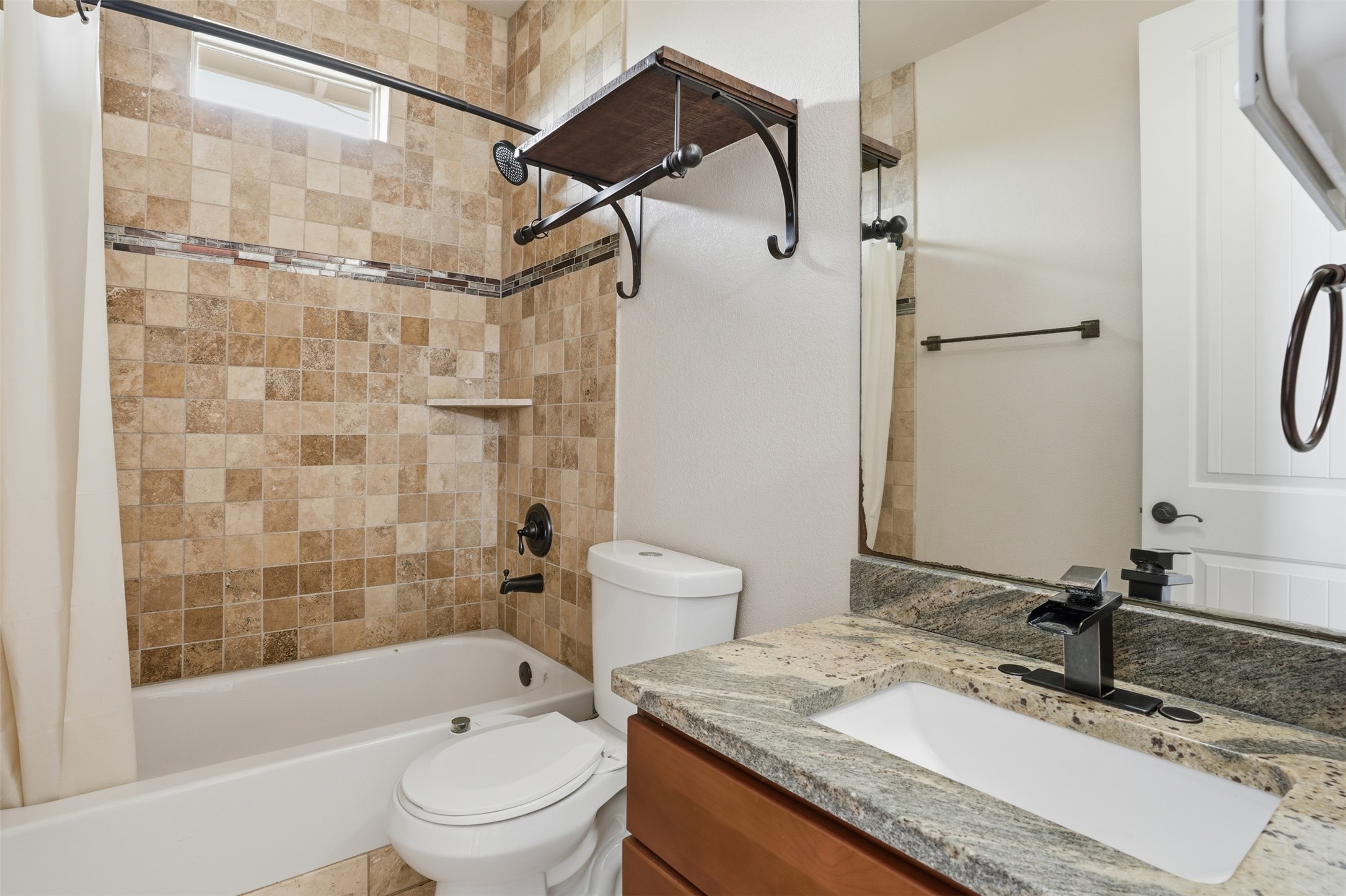 1185 Springdale Road Austin, TX 78721 - Photo 18 of 32 a bathroom with a granite countertop sink toilet and shower