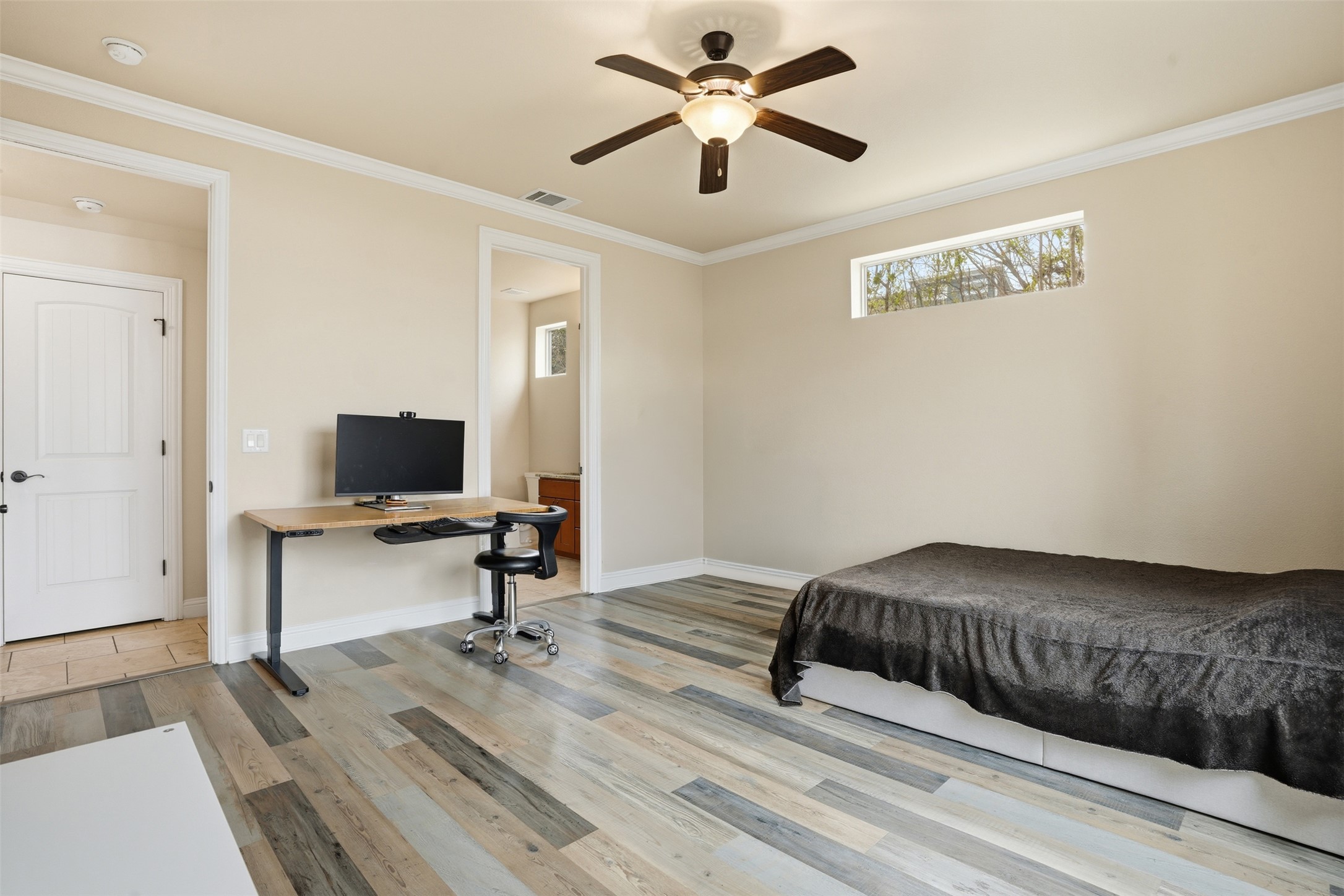 1185 Springdale Road Austin, TX 78721 - Photo 20 of 32 a bedroom with a bed and a chandelier