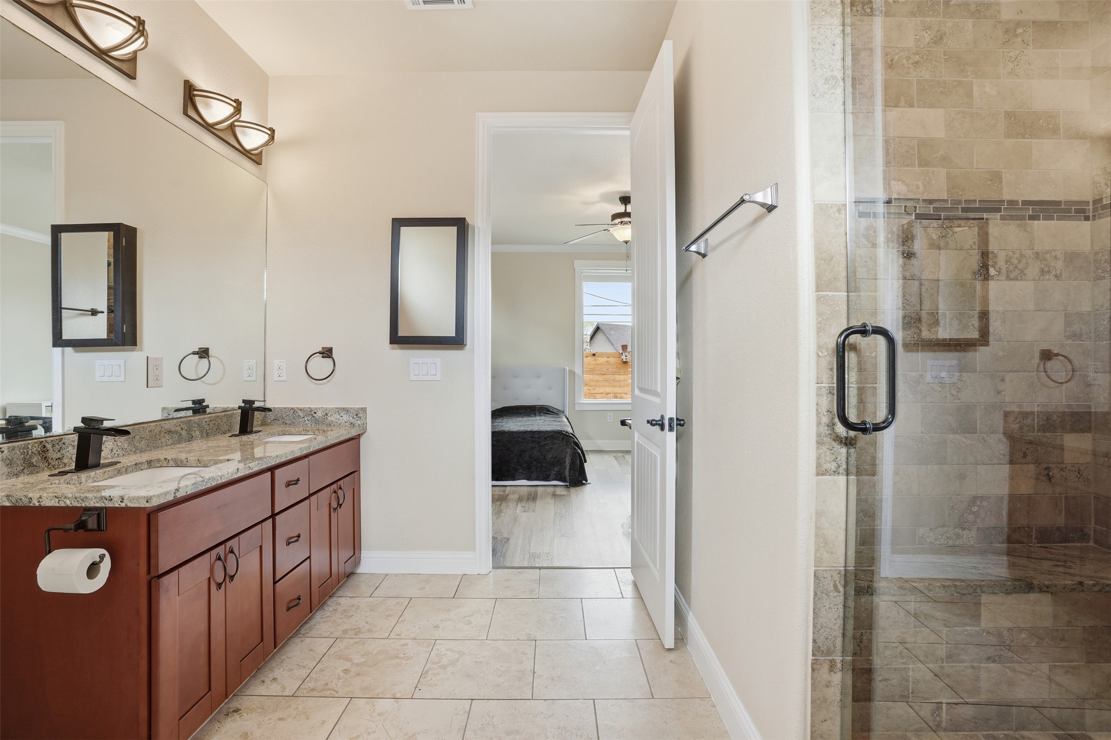 1185 Springdale Road Austin, TX 78721 - Photo 22 of 32 a bathroom with a granite countertop sink mirror and shower