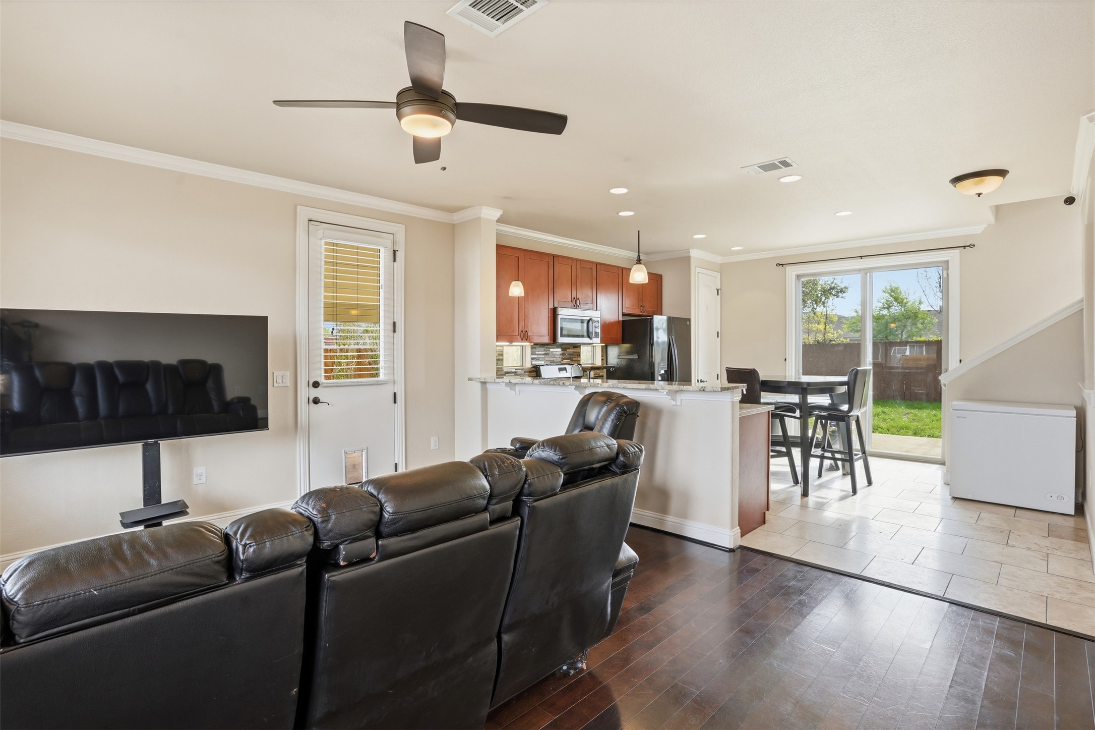 1185 Springdale Road Austin, TX 78721 - Photo 5 of 32 a living room with furniture a ceiling fan and a flat screen tv