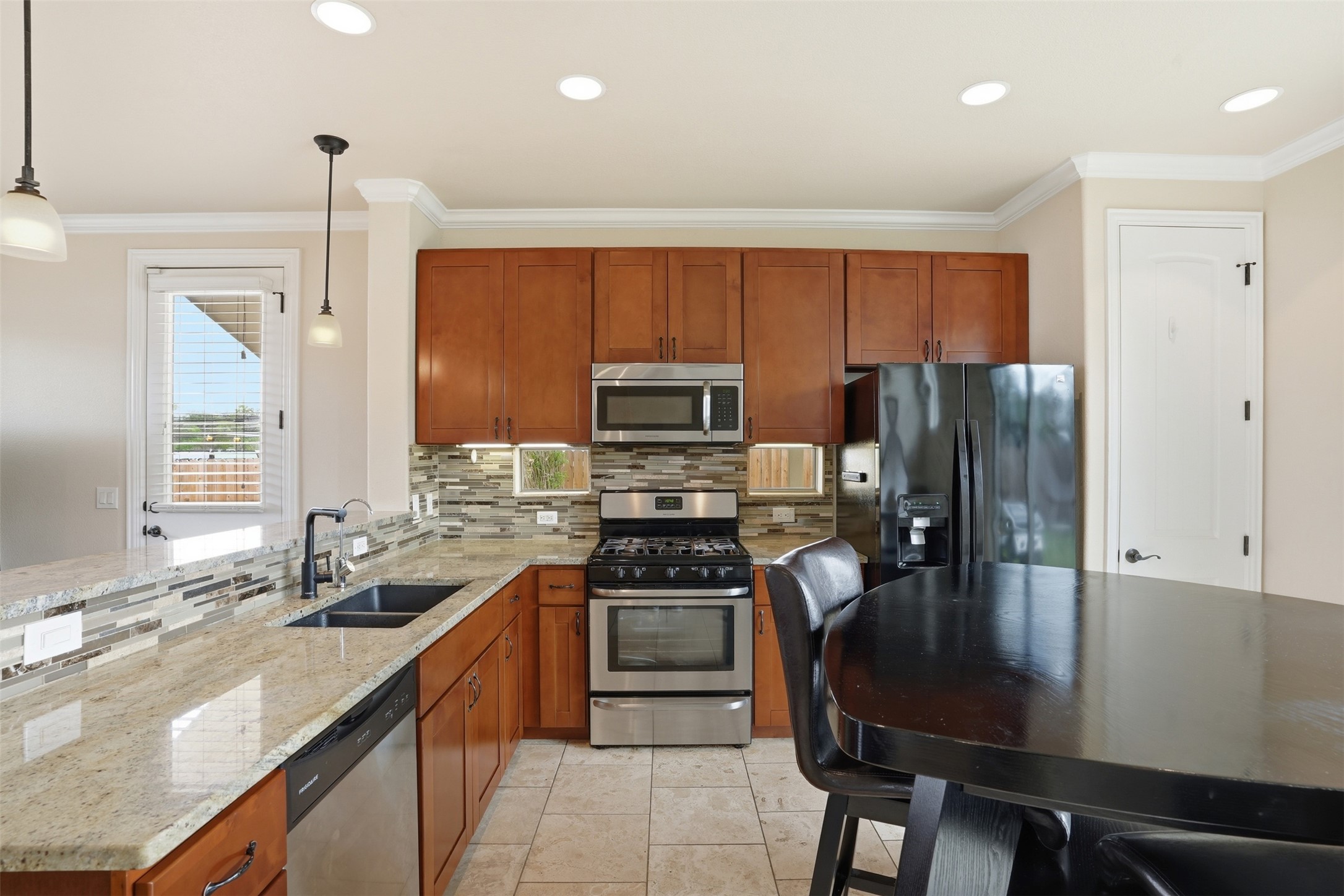 1185 Springdale Road Austin, TX 78721 - Photo 9 of 32 a kitchen with a refrigerator a stove a sink and dishwasher with wooden floor