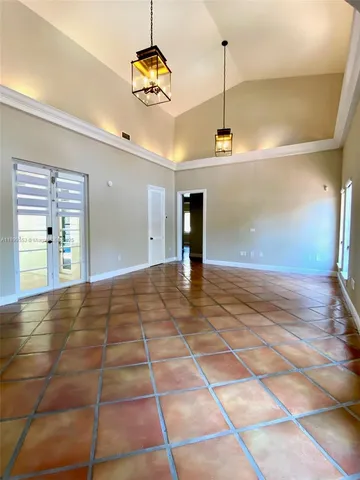 a view of a room with a window and chandelier