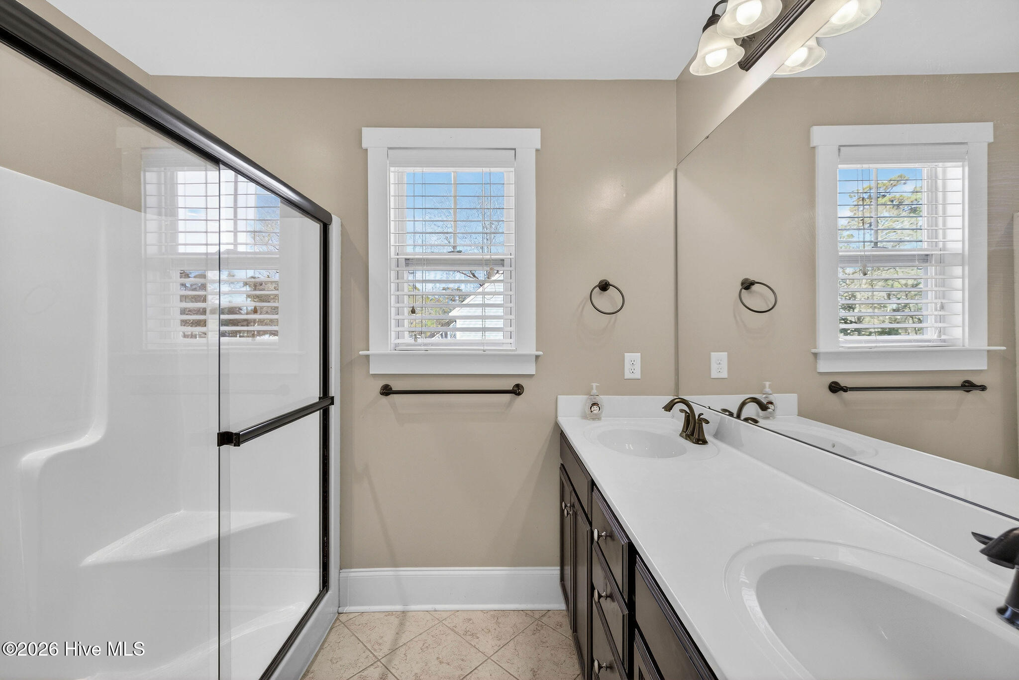 1727 Sloop Point Loop Road Hampstead, NC 28443 - Photo 42 of 55 Owner's suite features double sinks and walk-in shower.