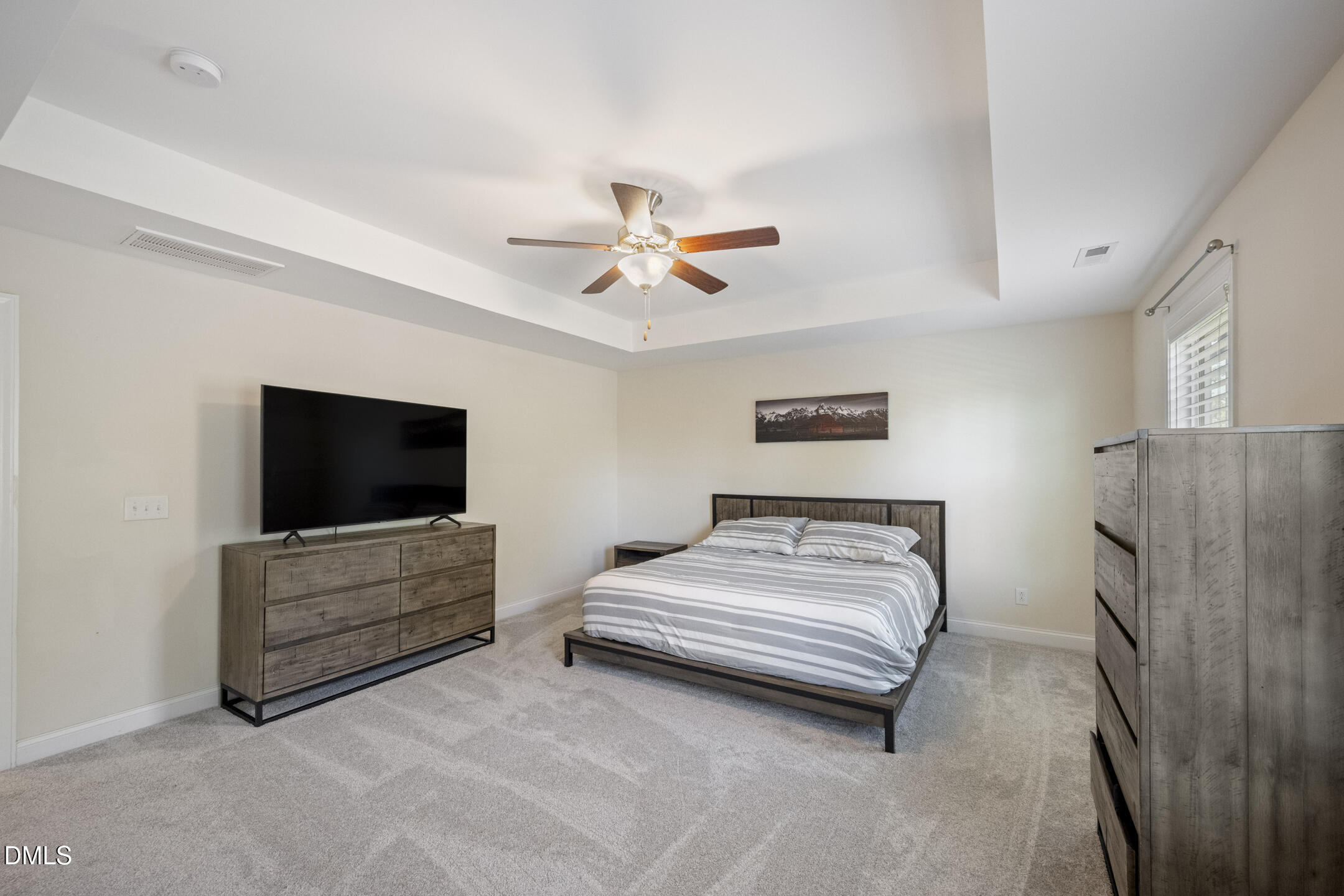 3541 Fairstone Road Wake Forest, NC 27587 - Photo 19 of 39 a bedroom with a bed and a flat screen tv