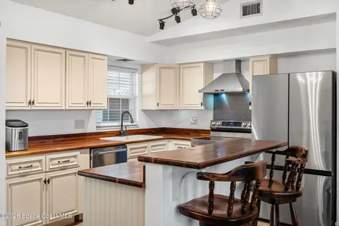 a kitchen with stainless steel appliances a sink a stove and a refrigerator
