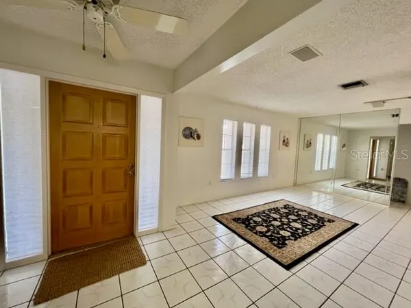 a view of a livingroom with wooden floor and a rug