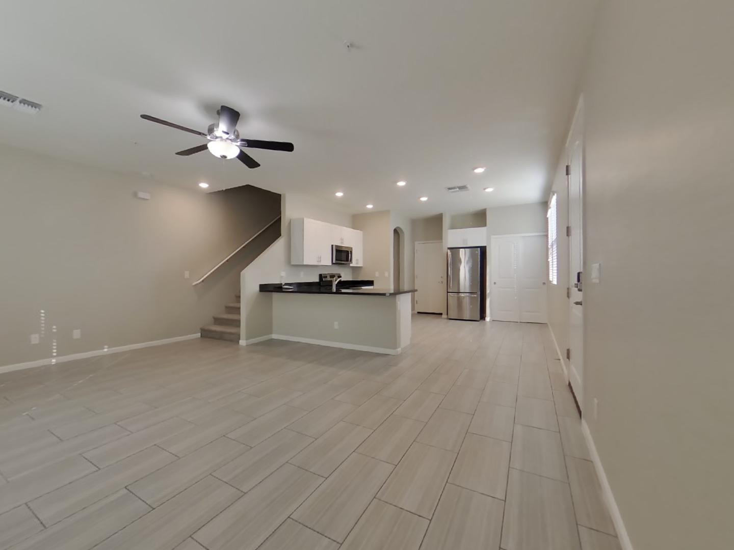 12565 West Via Dona Road Peoria, AZ 85383 - Photo 3 of 17 a view of an empty room with a kitchen