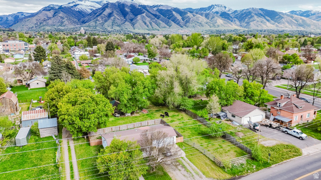 244 North 600 West Logan, UT 84321 - Photo 7 of 30 Expansive property featuring multiple structures, mature trees, open green spaces, and a mountainous backdrop