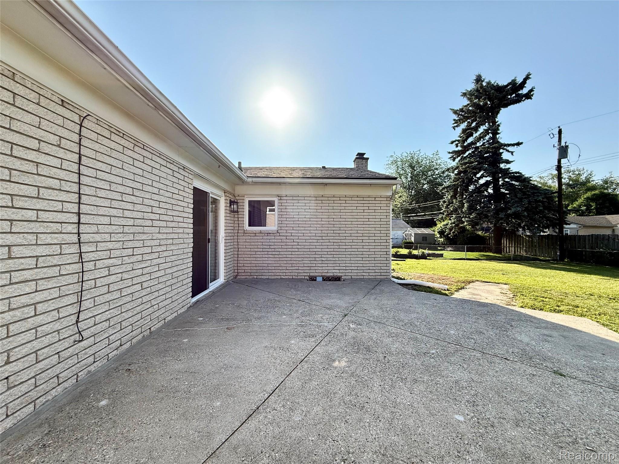39909 Lynn Street Canton, MI 48187 - Photo 41 of 45 Exterior patio featuring a concrete surface, brick siding, and a sliding glass door