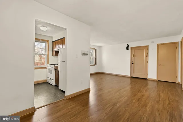 a view of empty room with wooden floor