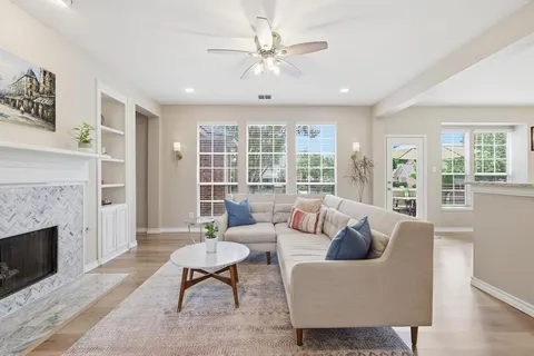 a living room with furniture and a fireplace