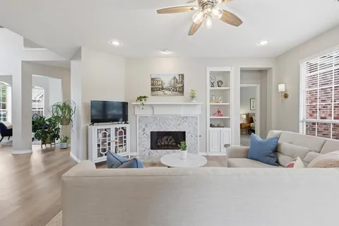 a living room with furniture a fireplace and a flat screen tv