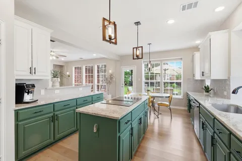 a kitchen with sink stove and cabinets