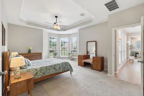 a bedroom with a bed couch and a window
