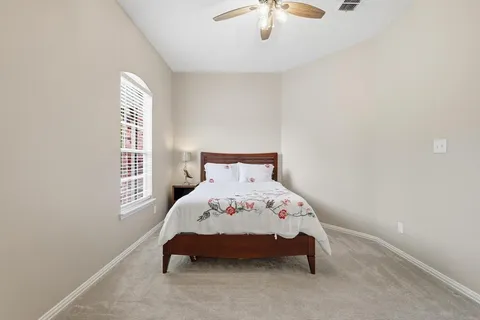 a bedroom with a bed and window