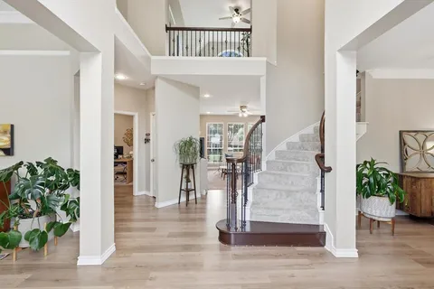 a view of entryway and hall with wooden floor