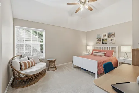 a bedroom with furniture and a large window