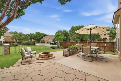 a lawn chairs sitting under a blue umbrella