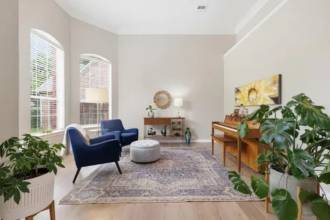 a living room with furniture and a potted plant