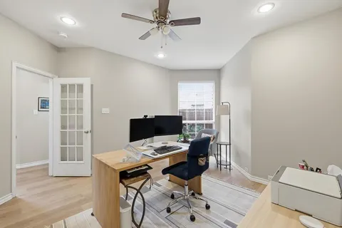 a view of a workspace with furniture and wooden floor