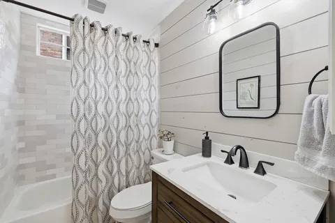 a bathroom with a sink toilet and shower