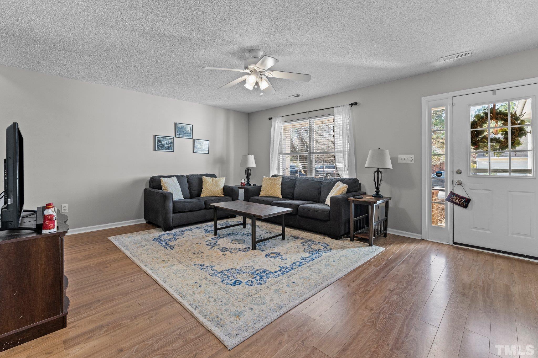 506 Ashford Lane Durham, NC 27713 - Photo 2 of 27 a living room with furniture and a flat screen tv
