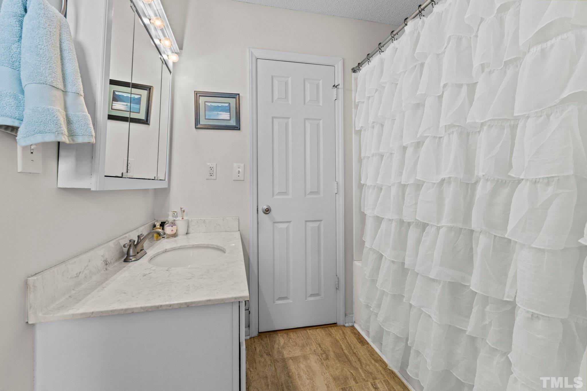 506 Ashford Lane Durham, NC 27713 - Photo 12 of 27 a bathroom with a sink and a mirror