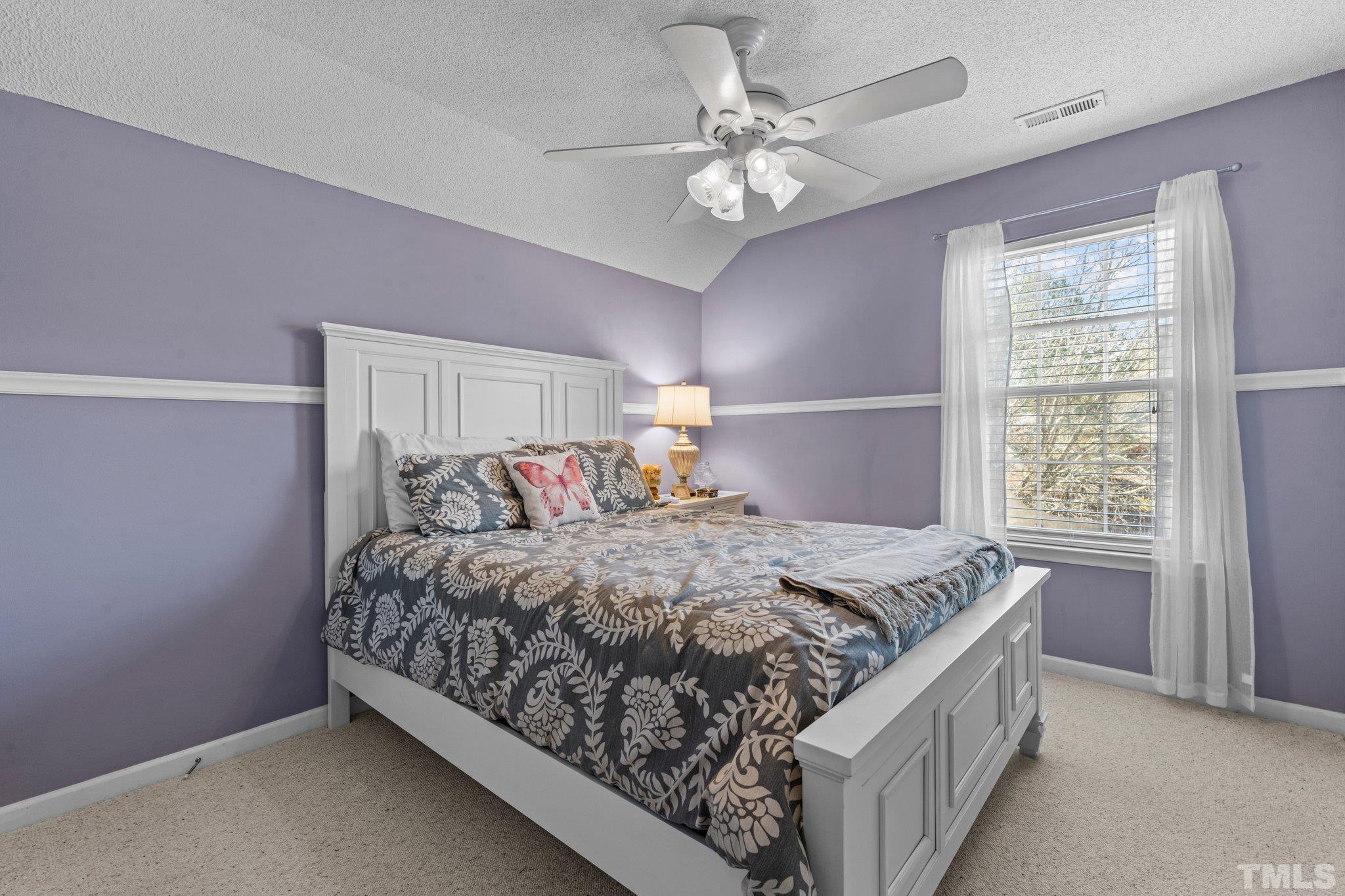 506 Ashford Lane Durham, NC 27713 - Photo 13 of 27 a bed sitting in a bedroom next to a window