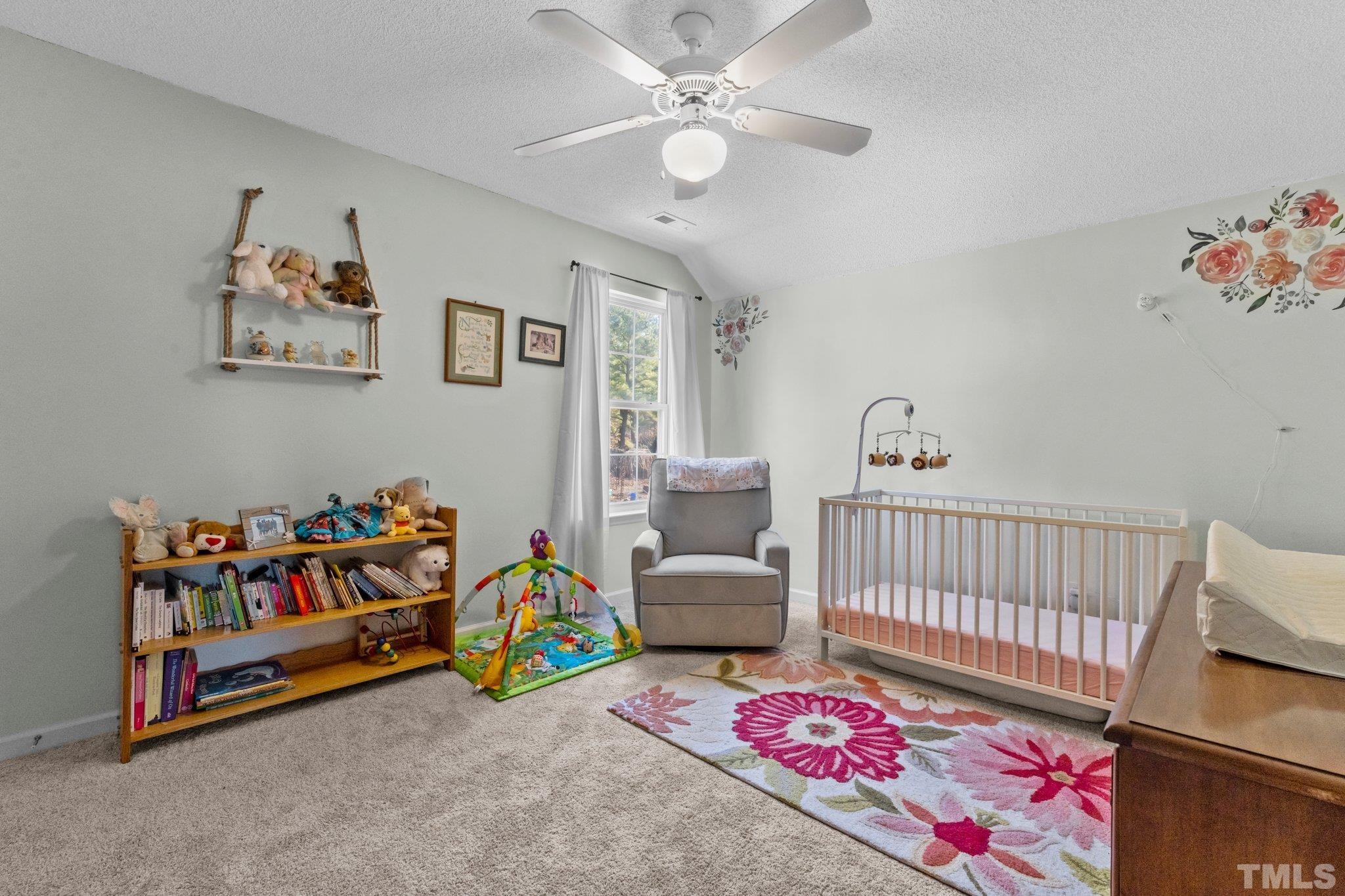 506 Ashford Lane Durham, NC 27713 - Photo 15 of 27 a bedroom with baby crib and a couch