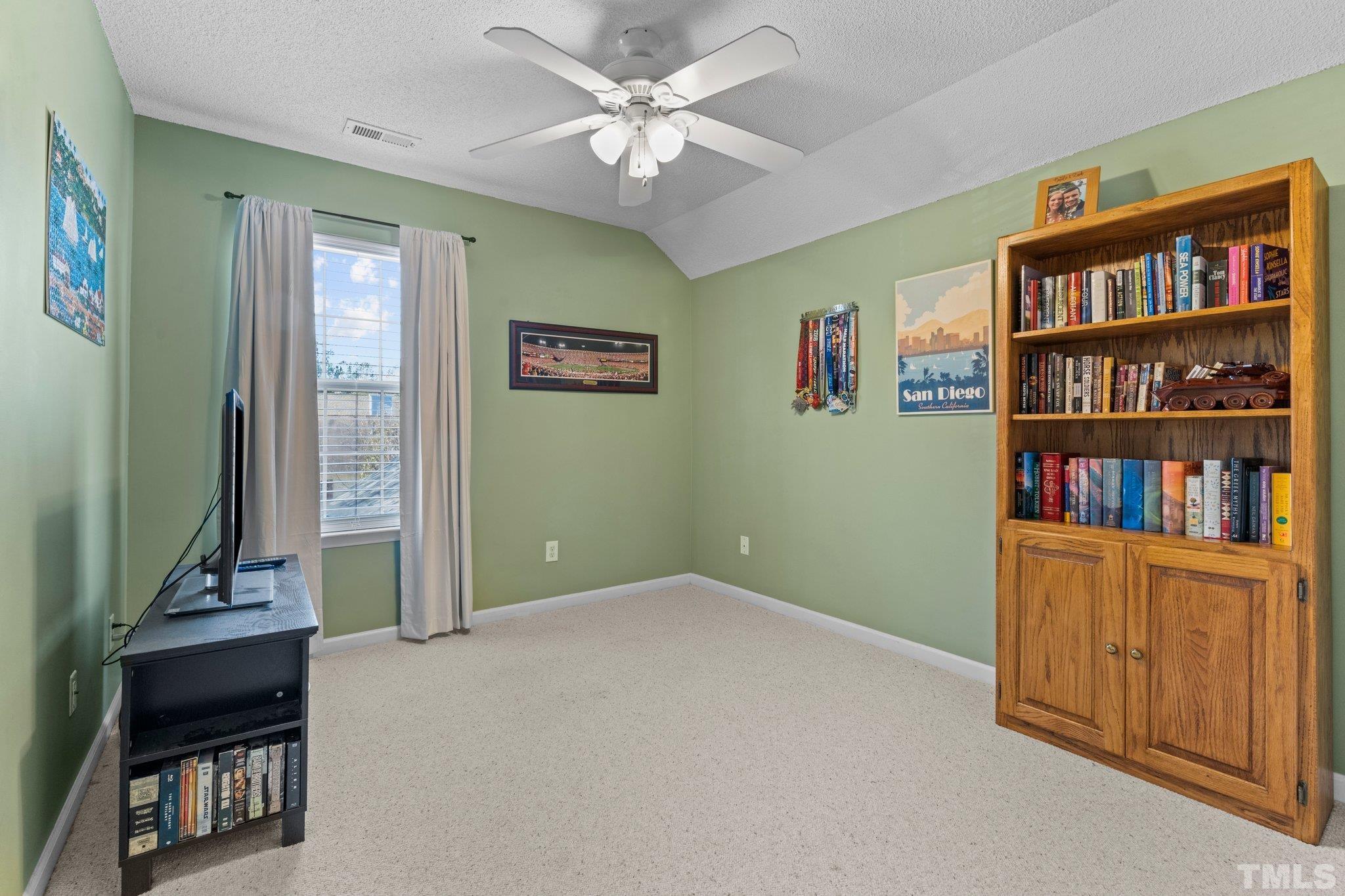 506 Ashford Lane Durham, NC 27713 - Photo 16 of 27 a view of room with window and book shelf